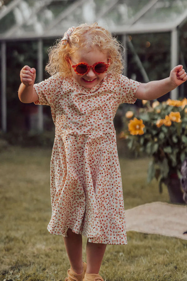 Sweetheart Twirl Dress in Sunset Meadow, organic cotton jersey, perfect for baby swimwear. Angle 3 view.