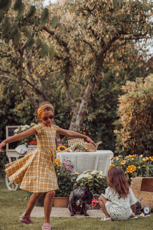 Sweetheart Twirl Dress in Buckwheat Plaid, organic cotton jersey, perfect for baby swimwear. Angle 6 view.