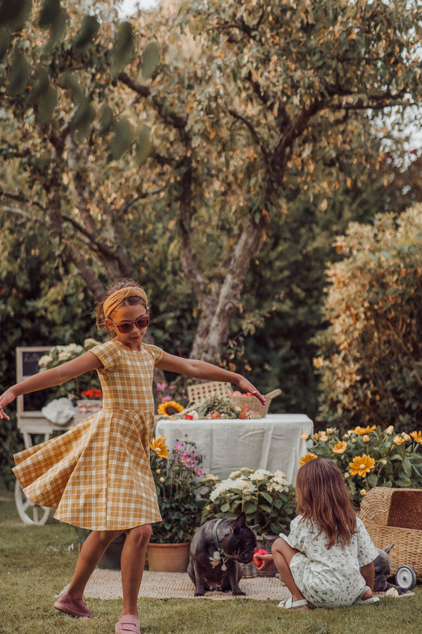 Sweetheart Twirl Dress in Buckwheat Plaid, organic cotton jersey, perfect for baby swimwear. Angle 6 view.