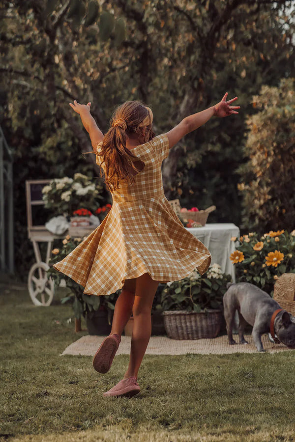 Sweetheart Twirl Dress in Buckwheat Plaid, organic cotton jersey, perfect for baby swimwear. Angle 7 view.