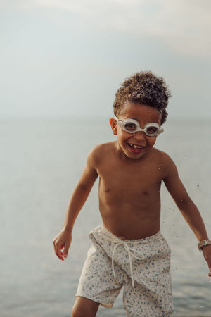 Baby swim trunks in Scandi floral design, UPF protection, and made from recycled materials - angle view.