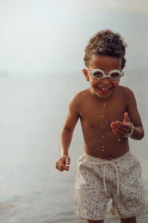 Baby swim trunks in Scandi floral design, UPF protection, and made from recycled materials, shown from angle 3.