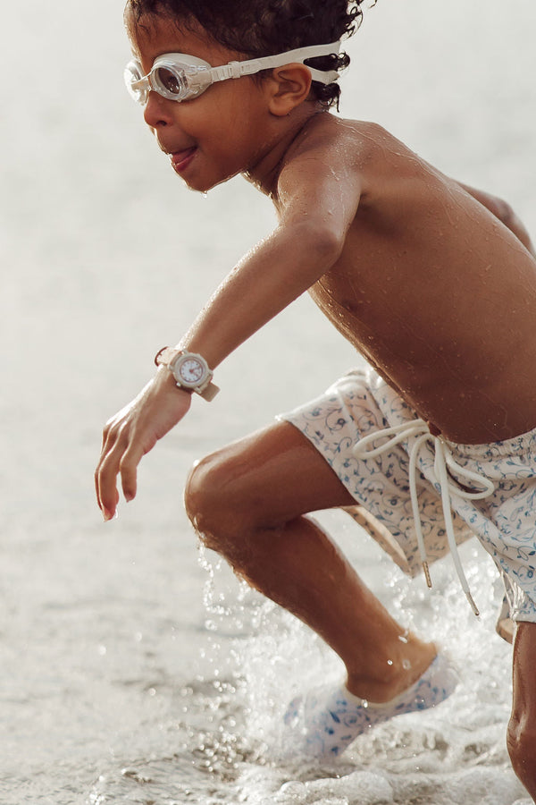 Baby swim trunks in Scandi floral design, UPF protected and made from recycled materials, shown at angle 8.