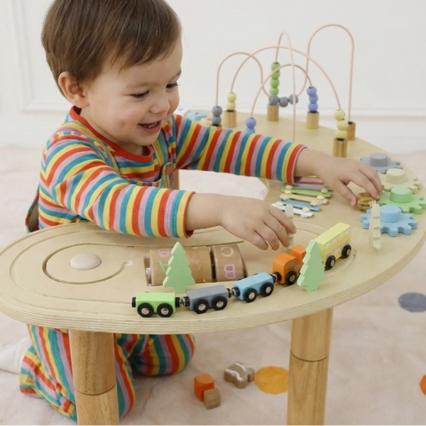 Wooden multi-activity sensory play table for babies, featuring engaging textures and colors, angled view.