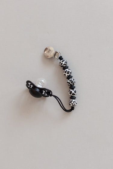 Lauren Clip in Cow design - stylish and functional pacifier clip for babies.
