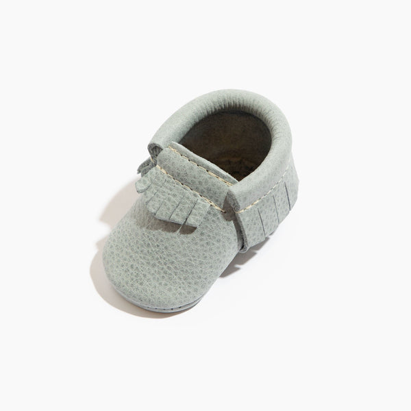 Newborn Greatest Snow on Earth Moccasin Baby Shoe, angle 2, featuring soft suede and cozy design for little feet.