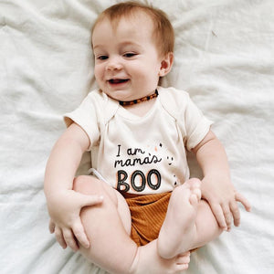 Graphic bodysuit from Mamas Boo, short sleeve design, angle view showcasing playful print and soft fabric for babies.
