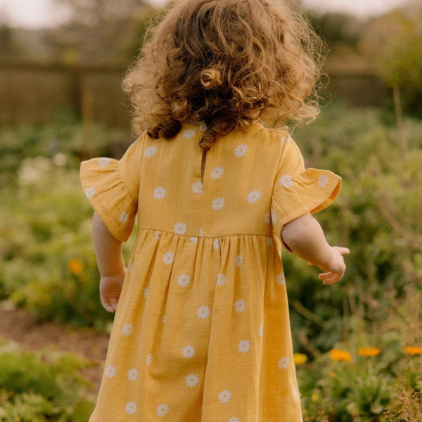 Clara Dress in Chamomile Sunshine Print, angle 5 view, perfect for baby girls' summer outfits.