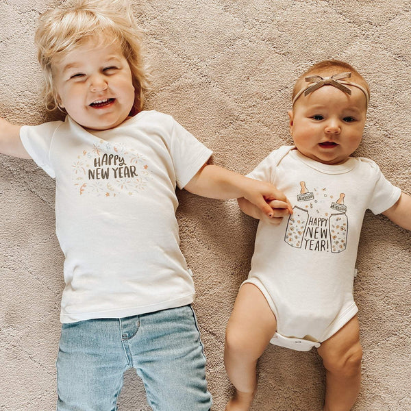 Short sleeve graphic bodysuit featuring "Poppin Bottles" design for babies, angled view showcasing its playful style.