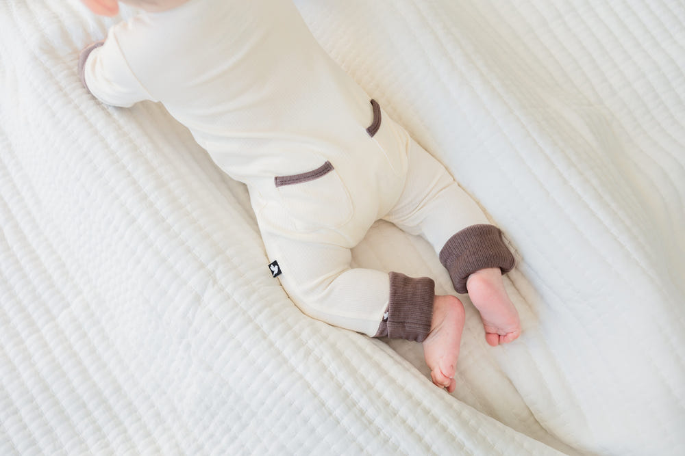 Oatmeal ribbed romper for babies, soft and stylish, perfect for everyday wear.