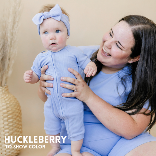 Solid ribbed bamboo zippy romper in various colors, shown from angle 2, perfect for babies.