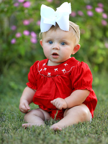Girls red romper with bow smocking and embroidery, perfect for stylish baby outfits.