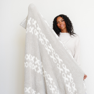 Double-layer Bamboni® throw blanket for babies, soft and cozy swaddle in a stylish angle view.