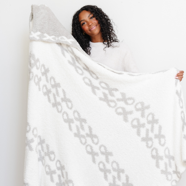 Double-layer Bamboni® throw blanket for babies, soft and cozy, perfect for swaddling and keeping warm.