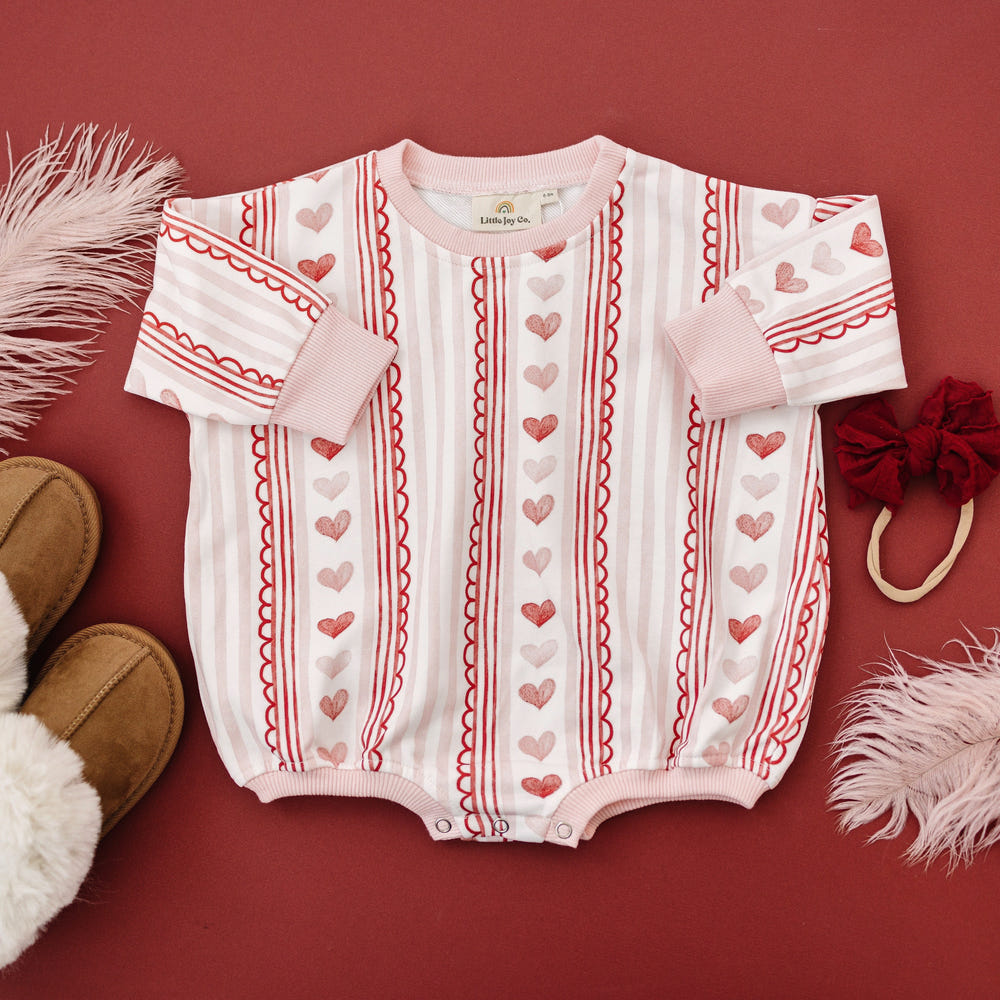 Laced with Love Sweatshirt Romper for babies in soft fabric, perfect for stylish comfort and playtime.