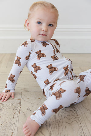 Cozy Bear Zippy zip pajamas for babies, featuring soft fabric and playful design, angled view showcasing details.
