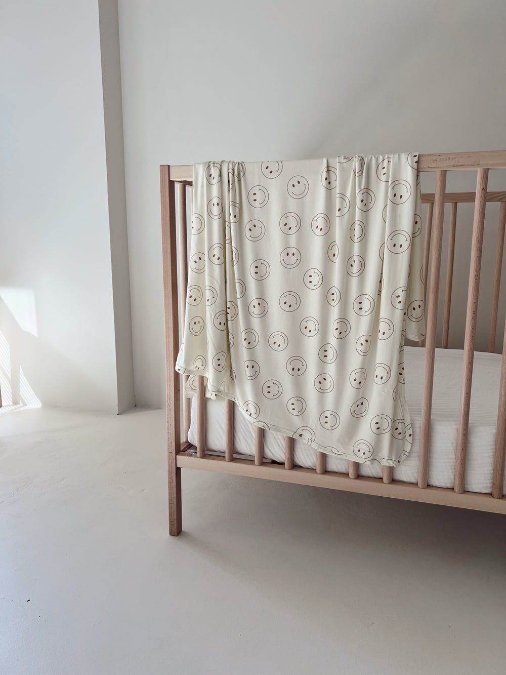 Soft bamboo swaddle blanket by Just Smile, perfect for keeping your baby cozy and comfortable.