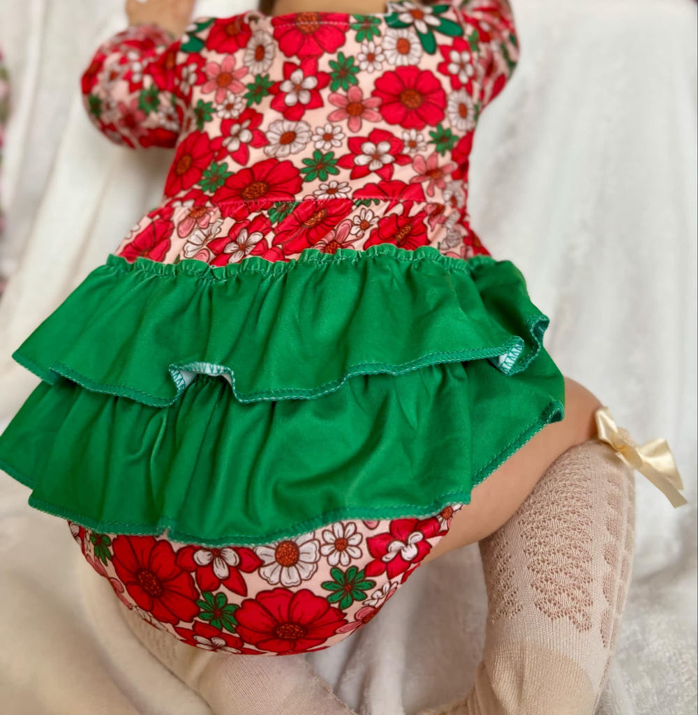 Christmas floral ruffle romper for babies, perfect for festive occasions and holiday celebrations.