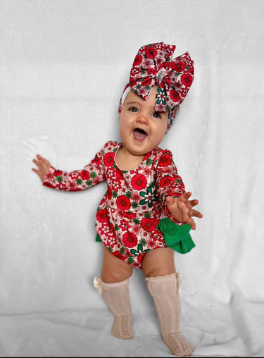 Christmas floral ruffle romper for babies, perfect for festive occasions and holiday celebrations.