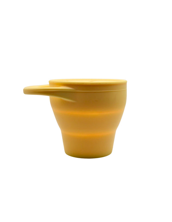 Silicone snack container for babies, angled view showcasing its spill-proof design and vibrant colors.