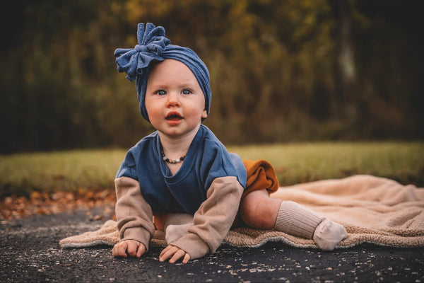 Color block sweatshirt romper for babies by Salt and Pine x LJC, displayed at angle 11.