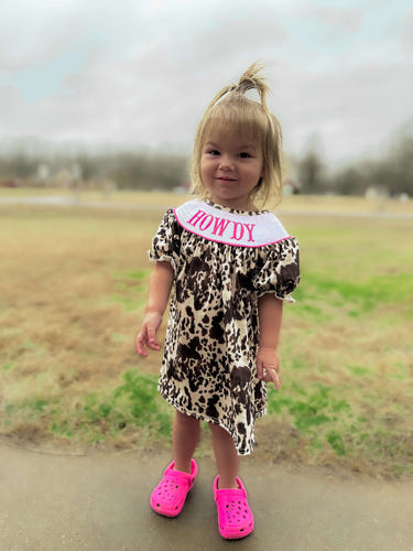 Smocked cowhide howdy dress for babies, stylish and comfortable clothing for little ones.