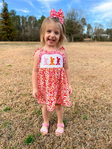 Smocked orange and pink leopard bunny dress for babies, perfect for playful and stylish outfits.