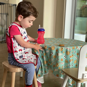 "Be Brave Firefighter Bapron for babies, angled view showcasing fun design and practical use."