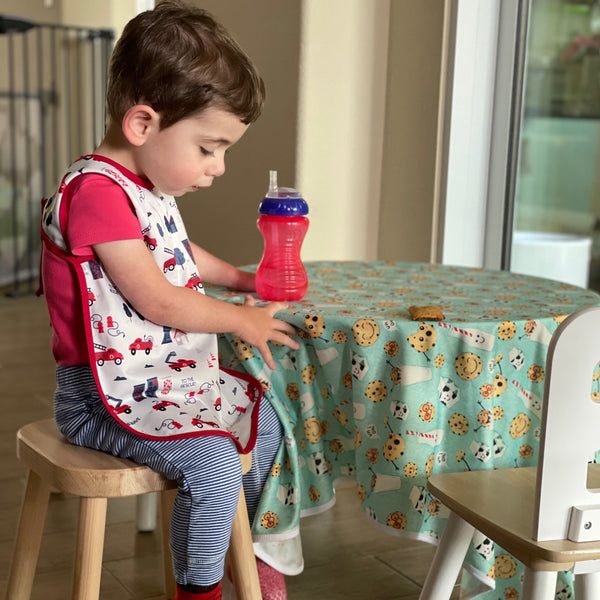 "Be Brave Firefighter Bapron for babies, angled view showcasing fun design and practical use."