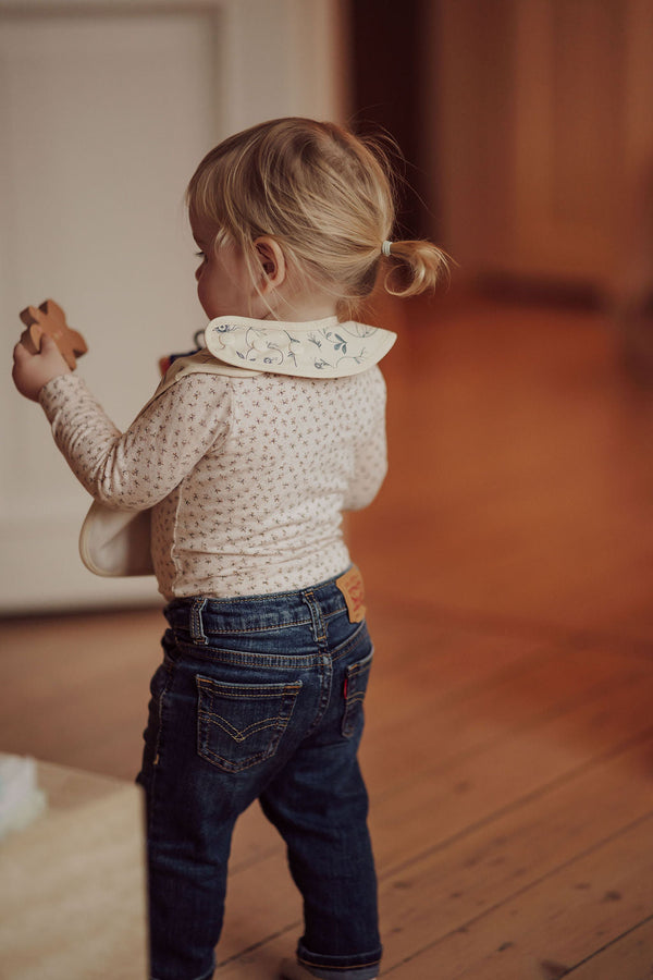 Scandi Floral Basic Bib in angle view, perfect for keeping babies clean during mealtime.