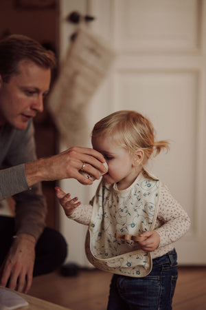 Scandi Floral Basic Bib in angle view, perfect for keeping baby clean during mealtime.