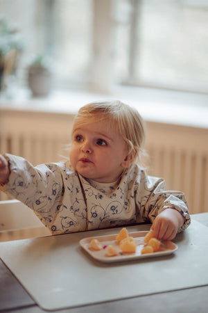 Scandi Floral Smock Bib for babies, featuring a stylish design and practical coverage, shown at angle 7.