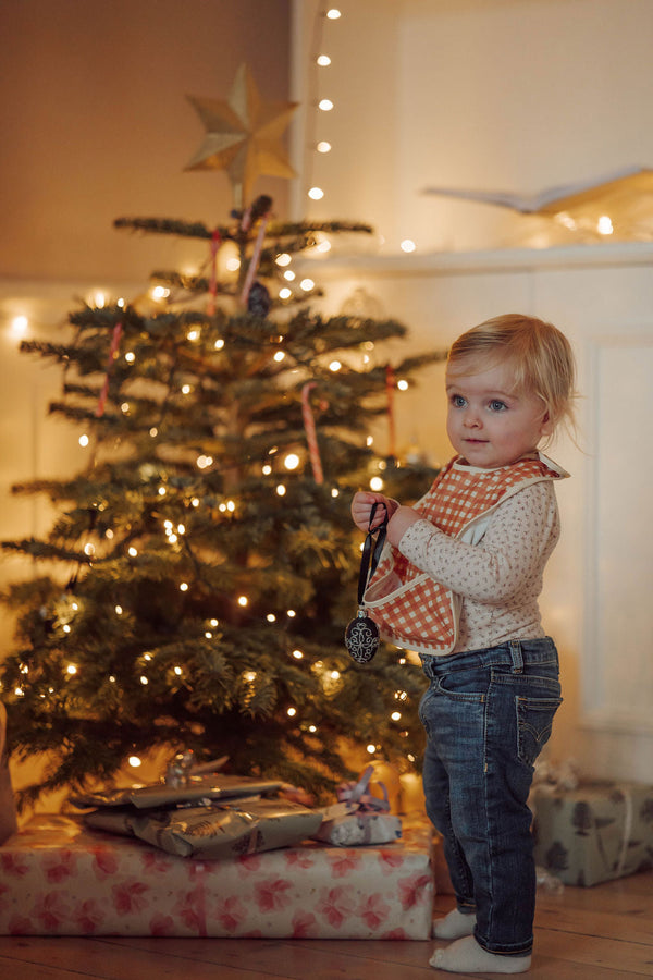 Sienna gingham basic bib for babies, angle view showcasing soft fabric and stylish design.