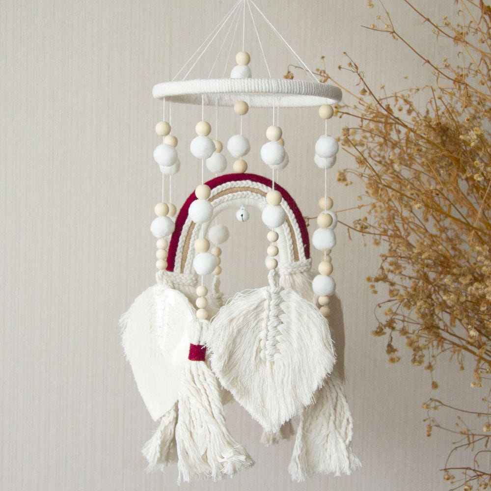 Handmade Boho nursery mobile featuring a macrame rainbow design for stylish baby room décor.
