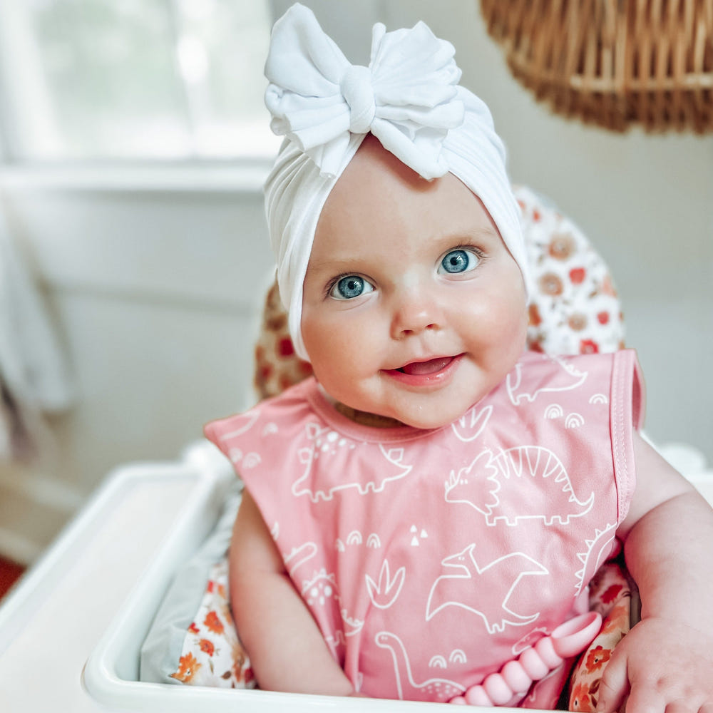 Dino Friends Blush Bapron for babies, stylish and practical feeding accessory with dinosaur design.