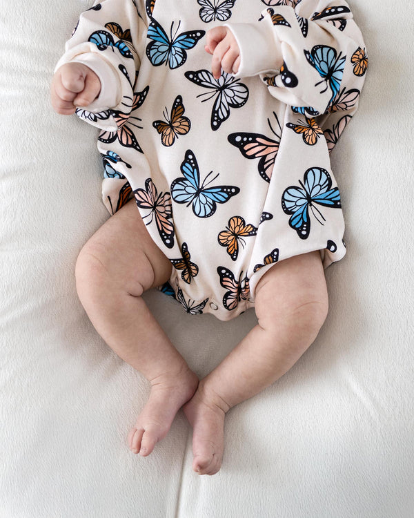 Baby bubble romper with butterfly print, angle view 3, perfect for playful outfits.