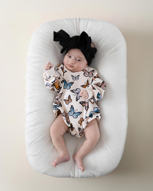 Baby bubble romper with butterfly design, angle view showcasing vibrant colors and playful style. Perfect for little ones!