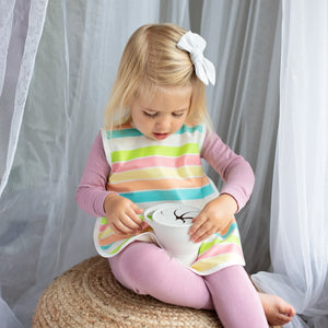 Rainbow Stripes Bapron for babies, angled view showcasing vibrant colors and practical design for mealtime messes.