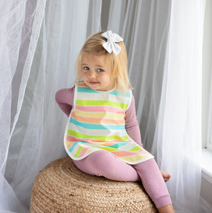 Rainbow Stripes Bapron for babies, angled view showcasing vibrant colors and playful design. Perfect for mealtime messes.