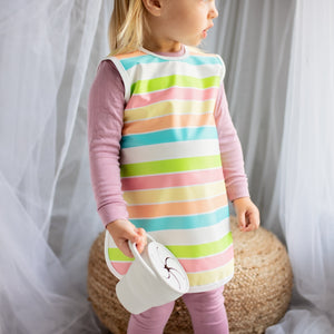 Rainbow Stripes Bapron for babies, angled view showcasing vibrant colors and practical design.