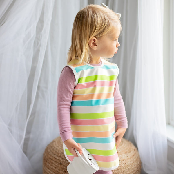 Rainbow Stripes Bapron for babies, angled view showcasing vibrant colors and unique design. Perfect for mealtime messes.