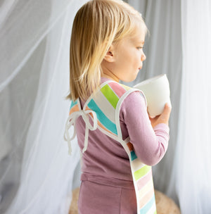 Rainbow Stripes Bapron for babies, angled view showcasing vibrant colors and unique design.