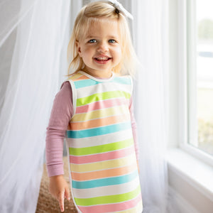 Rainbow Stripes Bapron for babies, angled view showcasing vibrant colors and practical design for mealtime messes.