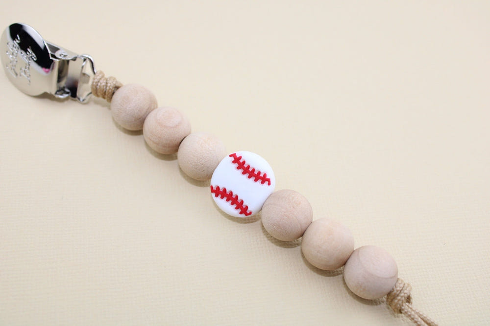 Baseball-themed pacifier clip for babies, keeping pacifiers secure and stylish.
