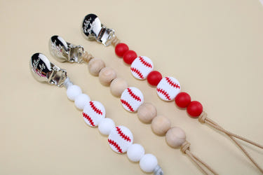 Baseball-themed pacifier clip for babies, keeping pacifiers secure and stylish.