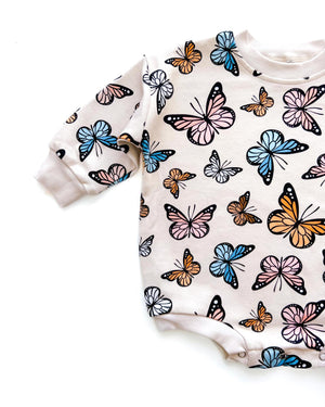 Baby bubble romper featuring colorful butterflies, perfect for playful outfits. Angle 4 view showcases design details.
