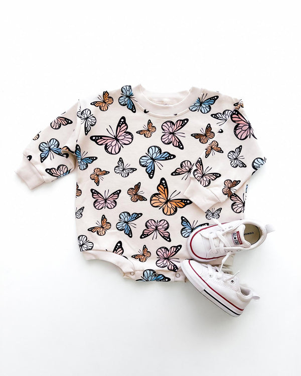 Butterfly print bubble romper for babies, shown from angle 2, perfect for playful and stylish outfits.
