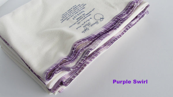 "Stretchy flat cloth diapers in various colors, angled view showcasing softness and flexibility for comfortable baby care."