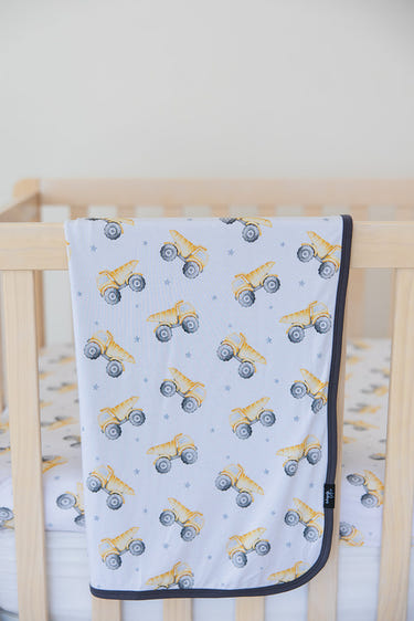 Baby dump truck blanket for swaddling, cozy and cute design for infants. Perfect for naps and playtime.