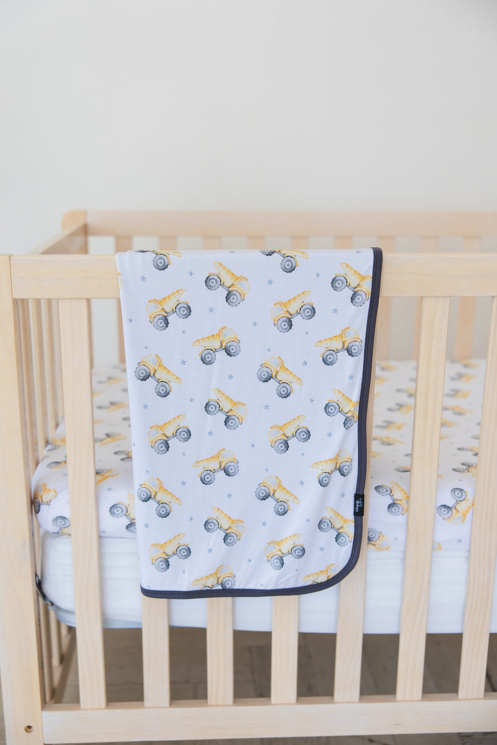 Baby dump truck blanket for swaddling, cozy and cute design for infants. Perfect for naps and playtime.